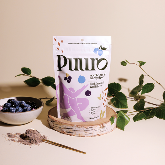 Puuro fiber powder on a piece of birch with a bowl and spoon on the side